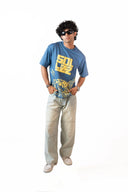 Sollzz Noctra - Silent Watcher Oversize Tee in dark navy blue featuring a male model with yellow Sollzz chest typography and a tiger artwork graphic print, styled with light washed relaxed jeans